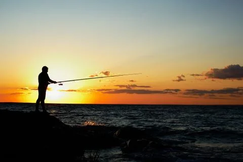 Fisherman at sunset Stock Photos