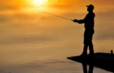 Fisherman in sunset Stock Photos