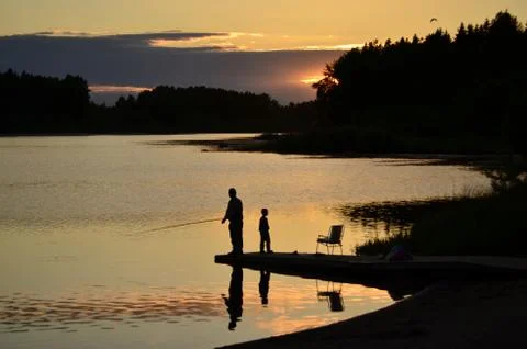 Fisherman in sunset Stock Photos