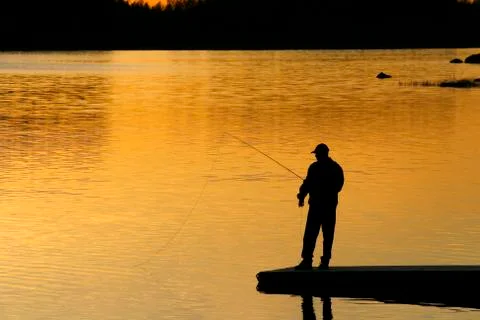Fisherman in sunset Stock Photos