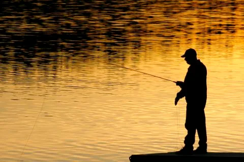 Fisherman in sunset Stock Photos