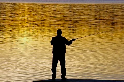 Fisherman in sunset Stock Photos