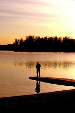 Fisherman in sunset Stock Photos