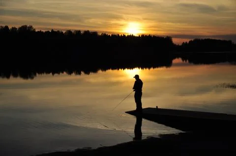 Fisherman in sunset Stock Photos