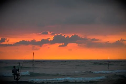 Fisherman at sunset Stock Photos