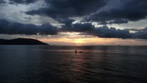 FISHERMAN ON THE SURFACE OCEAN AND SUNSET Stock Footage 276557554