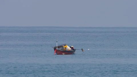 Fisherman taking a fish out of the net Video stock 233319663