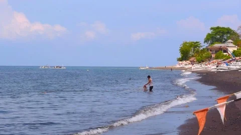 Fisherman is taking out his net from the sea in Amed, Bali. Video stock 100434076
