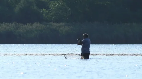 Man Throws Fishing Net Stock Footage ~ Royalty Free Stock Videos
