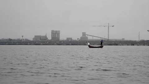 Fisherman throwing net Douala bay Stock Footage 80969032