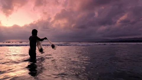 Fisherman throwing net at sunset Video stock 71707853