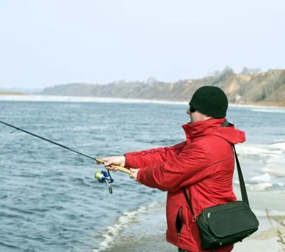Fisherman throws bait into the river Stock Photos