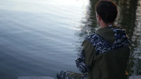 Fisherman throws the bait in the water, sitting on the pier. HD, 1920x1080, slow Stock Footage 101502852