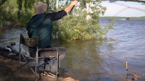 Fisherman throws a hook into the river Stock Footage 133162957