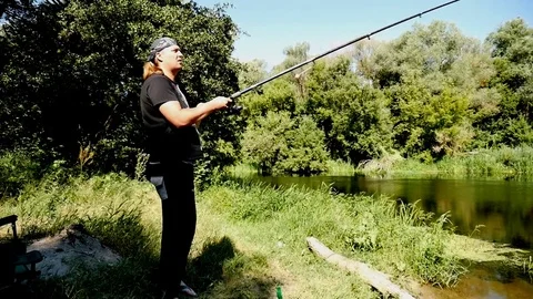 A fisherman throws a spinning 스톡 동영상 82182202