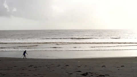 Fisherman Walking Along the Seashore During Monsoon Weather Stock Footage 343554529