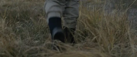 Fisherman walking in grass Stock Footage 68494181