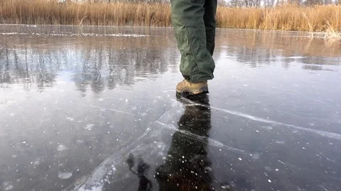 Fisherman is walking on slippery ice Video stock 101007800