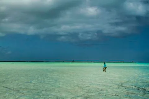 Fisherman walking a tropical flat Stock Photos