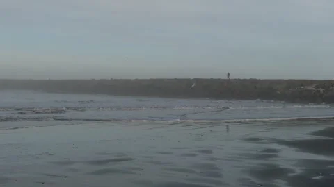 A fisherman walks down the jetty Video stock 305098714