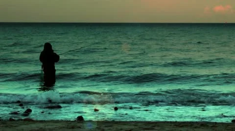 Fisherman in water at sunset Video stock 11863715