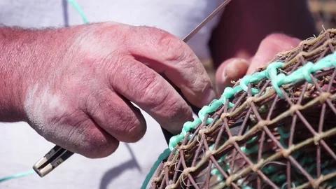 Fisherman working on fishing net slow motion Stock Footage