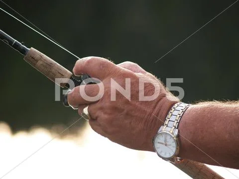 Fisherman's Hand on Reel Stock Photos