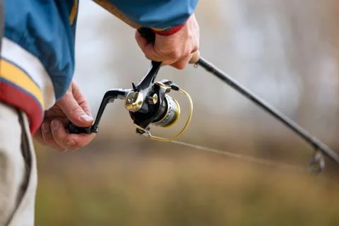 Fisherman`s hands with spinning. Stock Photos
