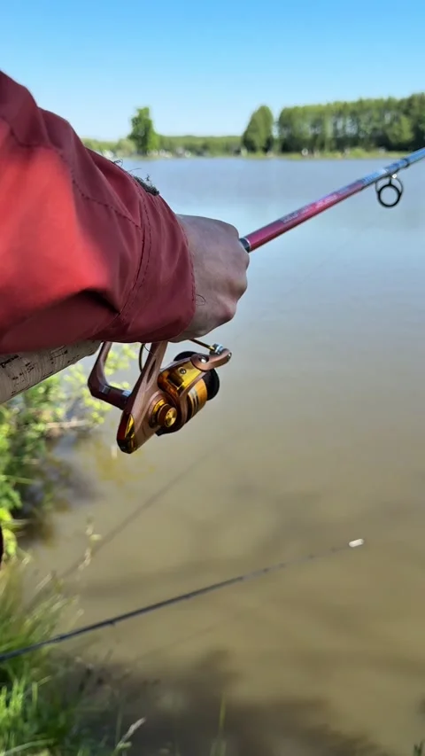 Fisherman’s hands spinning reel, close-up, smooth motion Stock Footage 310116728