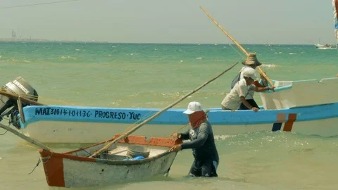 FISHERMEN AND BOATS AT PUERTO PROGRESO LIFE IN MERIDA YUCATAN MEXICO. Video stock 100799216