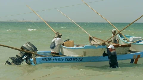 FISHERMEN AND BOATS AT PUERTO PROGRESO LIFE IN MERIDA YUCATAN MEXICO. Stock Footage 100799277