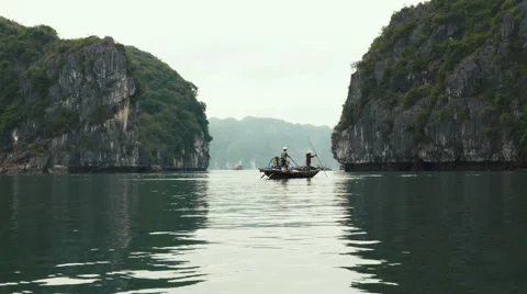 Fishermen and limestone mountains, Ha Long Bay Vietnam. Long shot, telephoto. Stock Footage 65477187