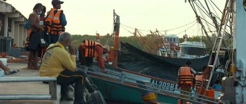 Fishermen are loading into the boat Stock Footage 232358897