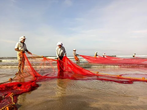 Fishermen at beach Stock Photos