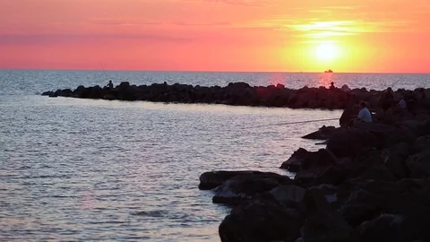 Fishermen on the beach at sunset Stock Footage 77680536