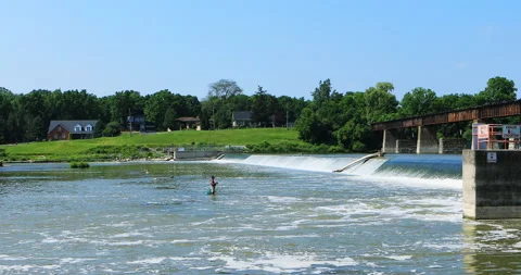Fishermen below train bridge and dam in Caledonia, Canada, exclusive 4K Stock Footage 170616637