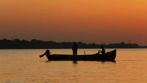 Fishermen on a boat at sunset Stock Footage 236106322