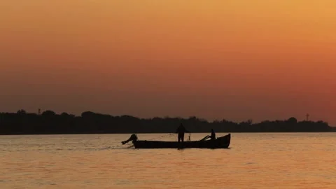 Fishermen on a boat at sunset Stock Footage 236106325
