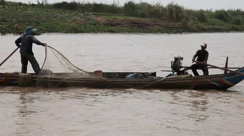 Fishermen cast nets from small boat on Tonle Sap float-by Phnom Penh Stock Footage 50622848