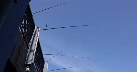 Fishermen casting fishing rods from bridge into sea 4k movie slow motion Stock-Footage 238532723