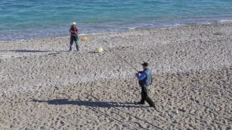  Fishermen catch fish on a fishing rod on the beach Stock Footage