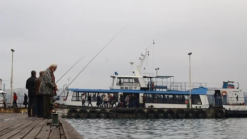 Fishermen catch fish on a pier Video stock 122951091