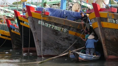 Fishermen embarking fishing boat in small boat,Phan Thiet,Vietnam Stock Footage