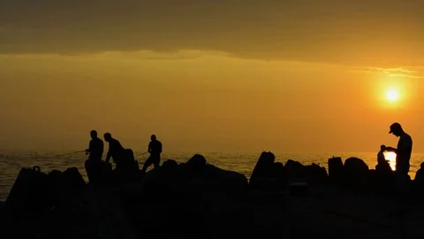 Fishermen fish in front of sunset Stock-Footage 78564072