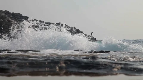 Fishermen fish on the on the rocks. Stock Footage 125781867