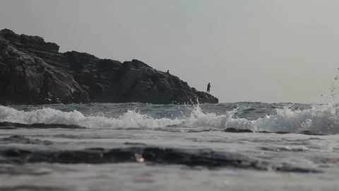 Fishermen fish on the on the rocks. Stock Footage 125781879