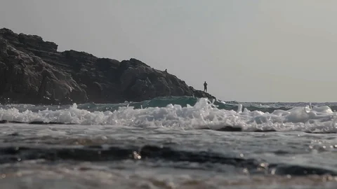 Fishermen fish on the on the rocks. Stock Footage 125781887