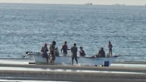 Fishermen help each other put the nets back Stock Footage 287057769