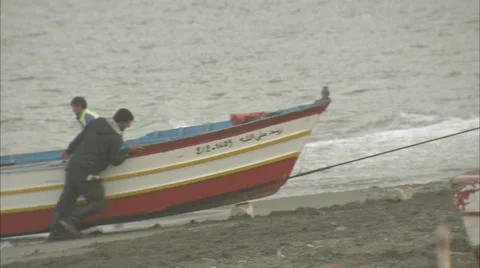 Fishermen landing their catch, pulling in a traditional fishing boat Stock Footage 38627015