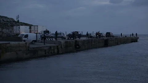Fishermen on the mole at dusk Stock Footage 108634135